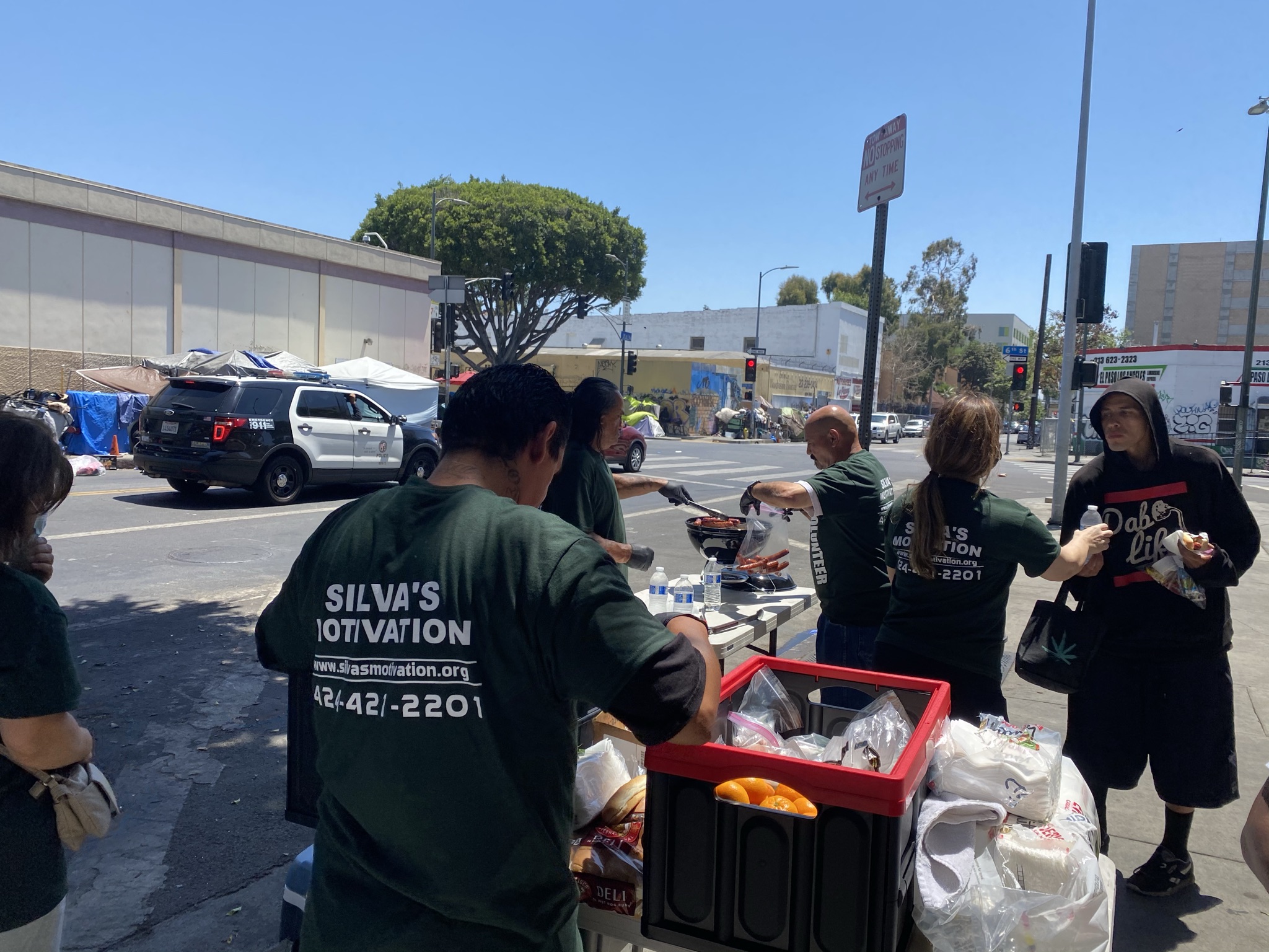 pictures of volunteers in green SM shirts serving food to the community