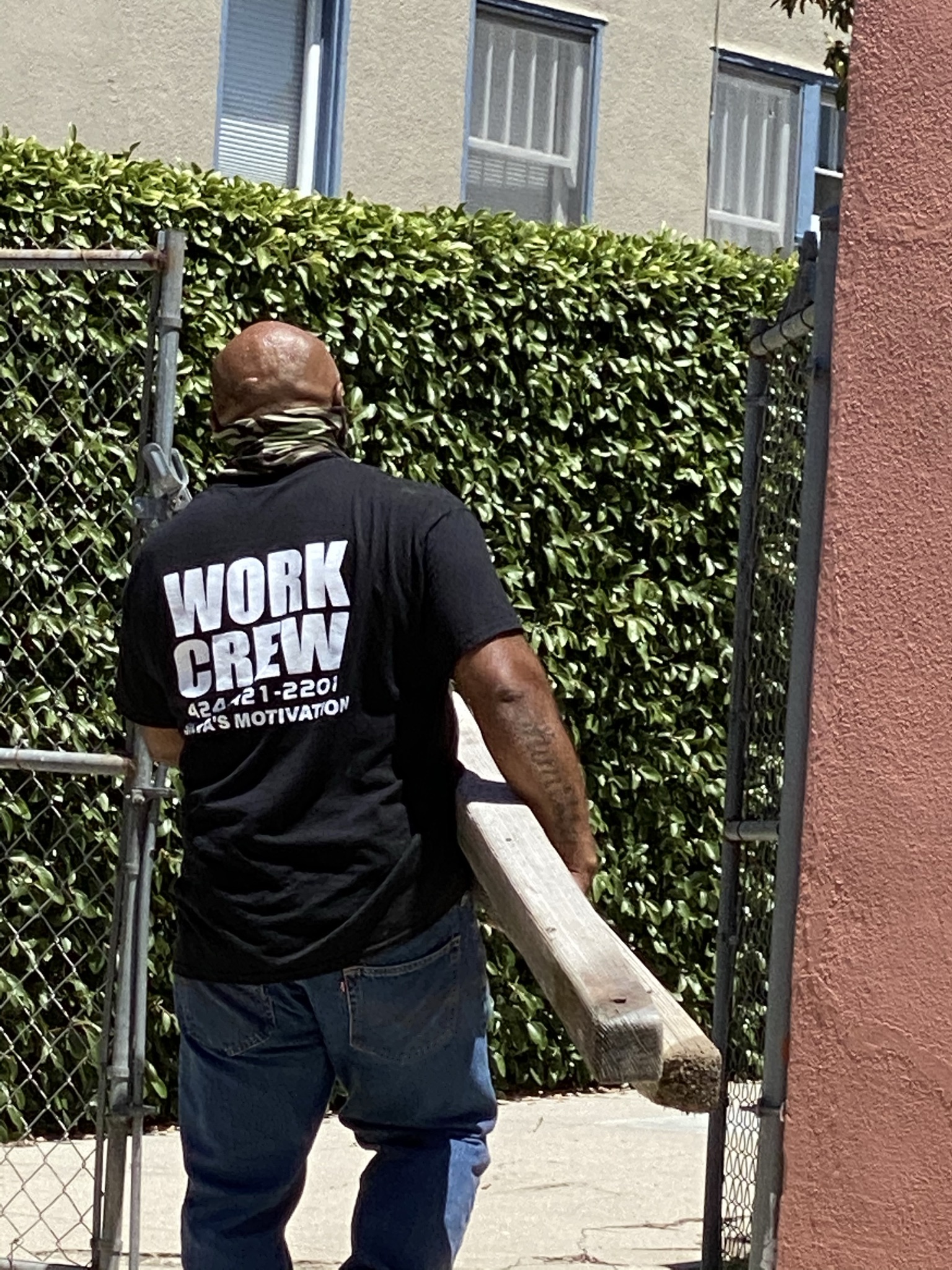 Volunteer moving wood.