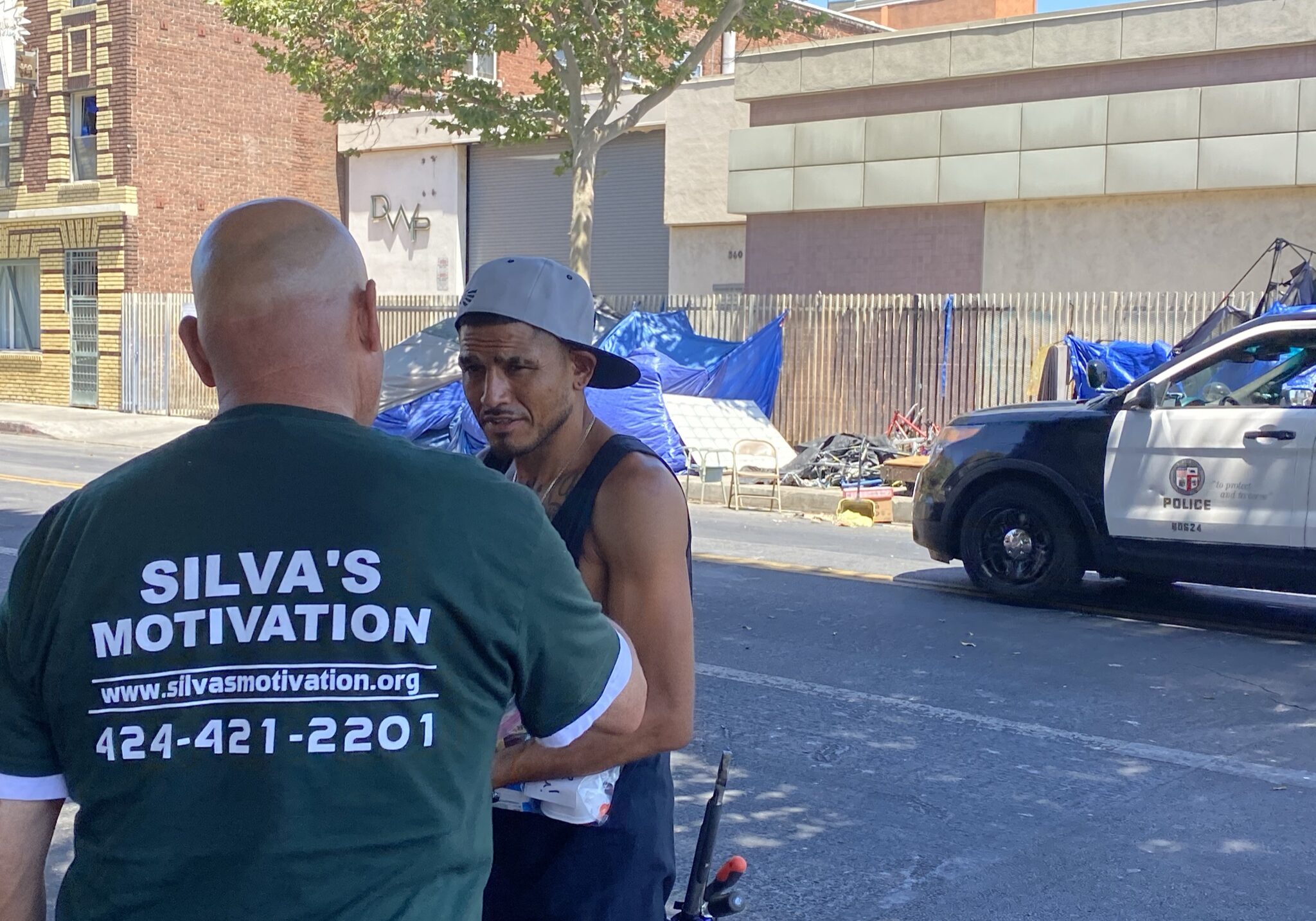 volunteer talking to a male on the street.